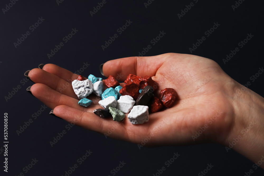 Sweets in the form of sea pebbles in the palms. Close-up Sweets in the form of sea pebbles in the palms. Close-up
