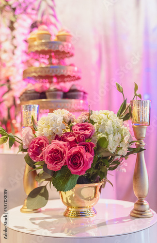 Elegant Bouquet of Flowers in a Vase with Gold Colored Crown Party Favors.