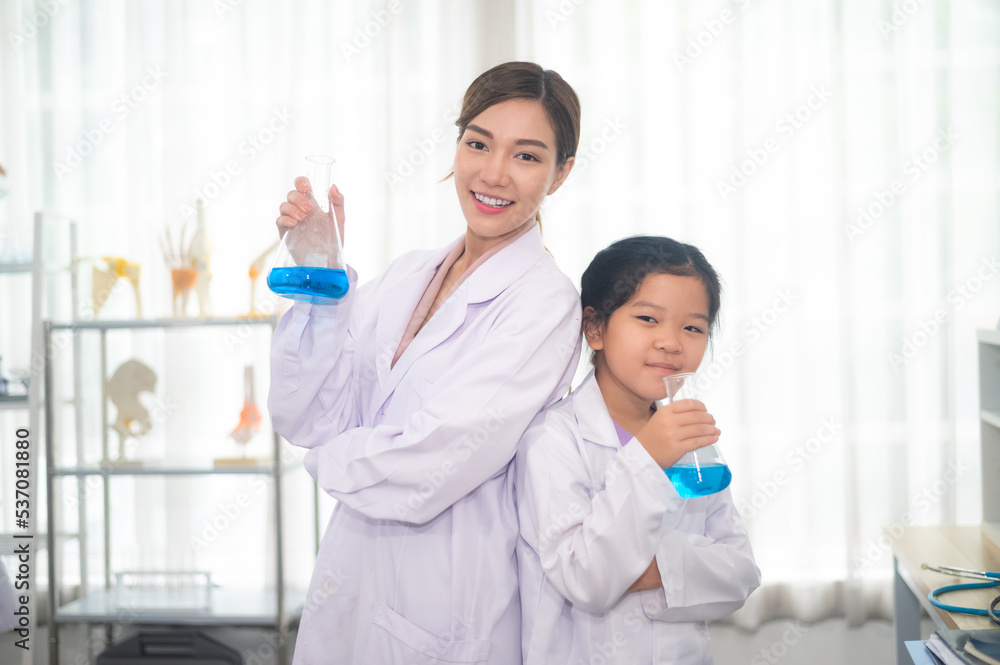 Education science school concept, Happy Asian woman teacher and student girl in science school ,Asian woman teacher and student design for Education science school Education science school concept, Happy Asian woman teacher and student girl in science school ,Asian woman teacher and student design for Education science school