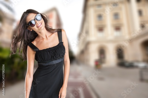 Fashionable woman posing on street background