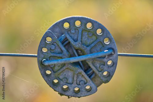 electric fence wire and rope tensioner , close up view photo