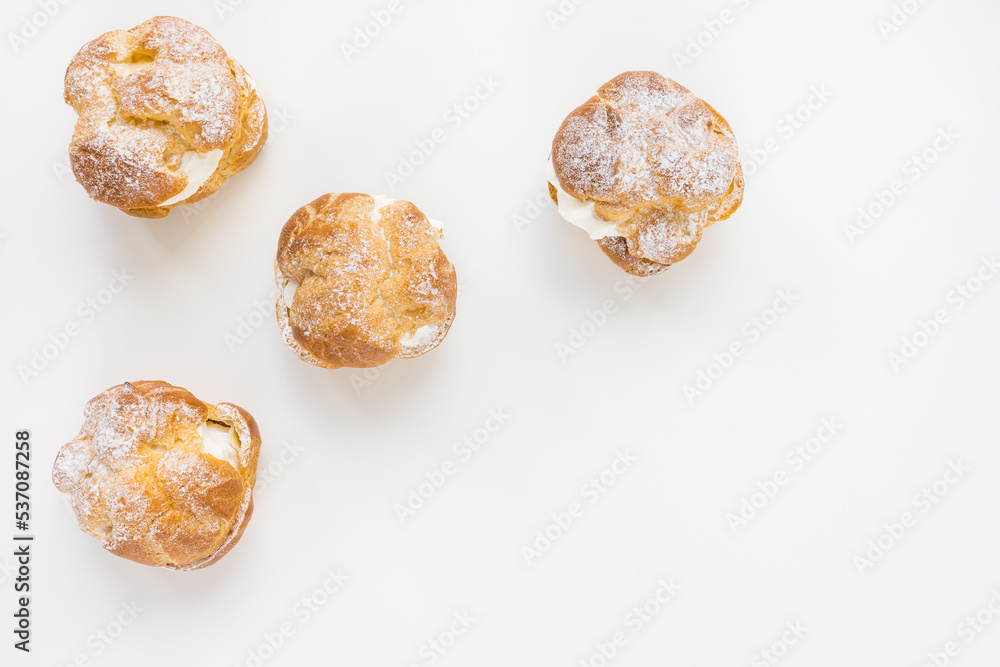 Choux Bun with whipped cream and sugar powder on top. French pastry