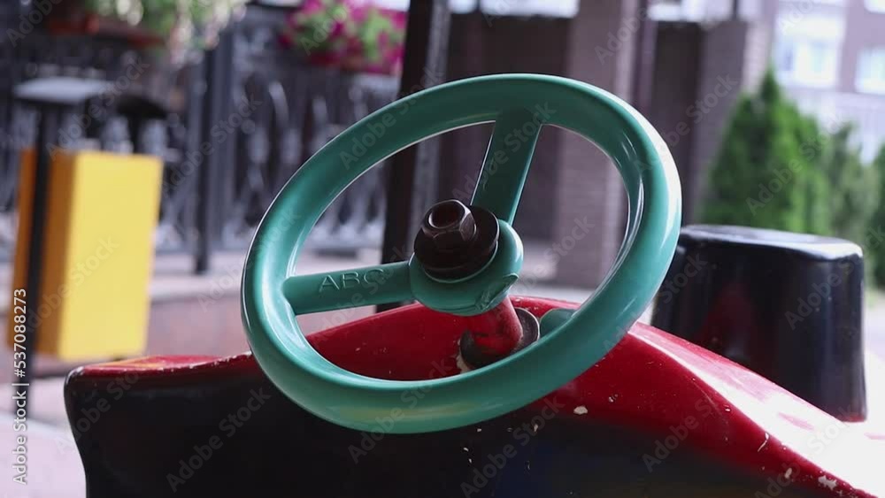 A child's hand turns the steering wheel. A child's hand turns the steering wheel.