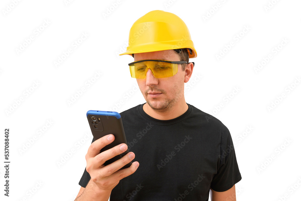 Male worker or builder in yellow helmet using smartphone isolated on white background. Construction concept Male worker or builder in yellow helmet using smartphone isolated on white background. Construction concept