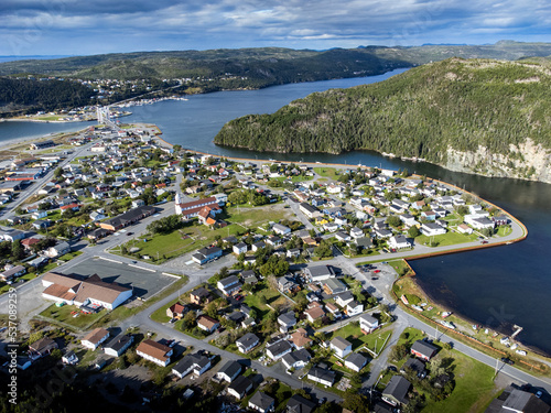 Aerial Newfoundland town and popular landmarks with a distant draw bridge and community heritage church. photo