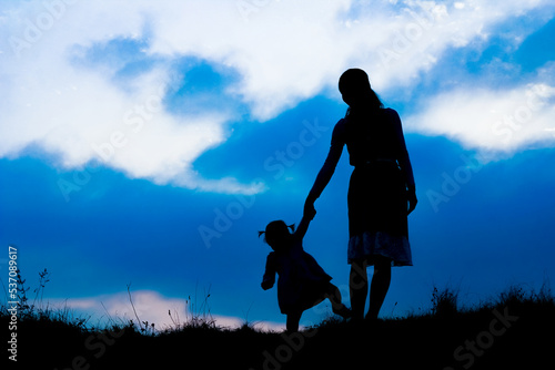 happy parent with child in the park outdoors silhouette © Kostia