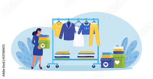 Cloth recycling. Woman packing box with clothes at wardrobe for donation. Recycle and sustainable fashion. Eco-friendly production fabric. People donate dress for benefaction. Charity, social care