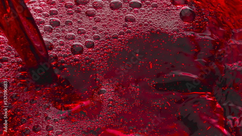 Fotografie Bubbled red wine pouring glass slow motion