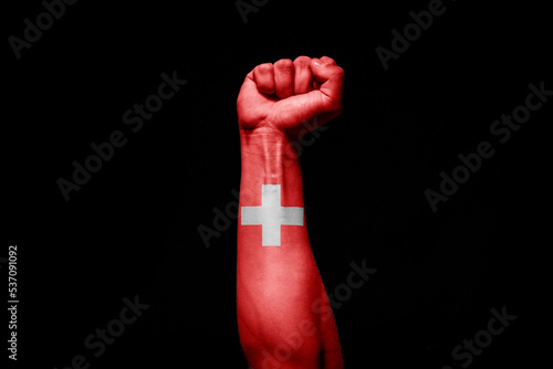 Man's hand in a fight signal with the countries flag. photo