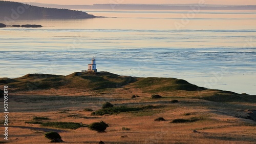 Scenic view of the Lime Kiln Lighthouse at sunset in San Juan County, Washington photo