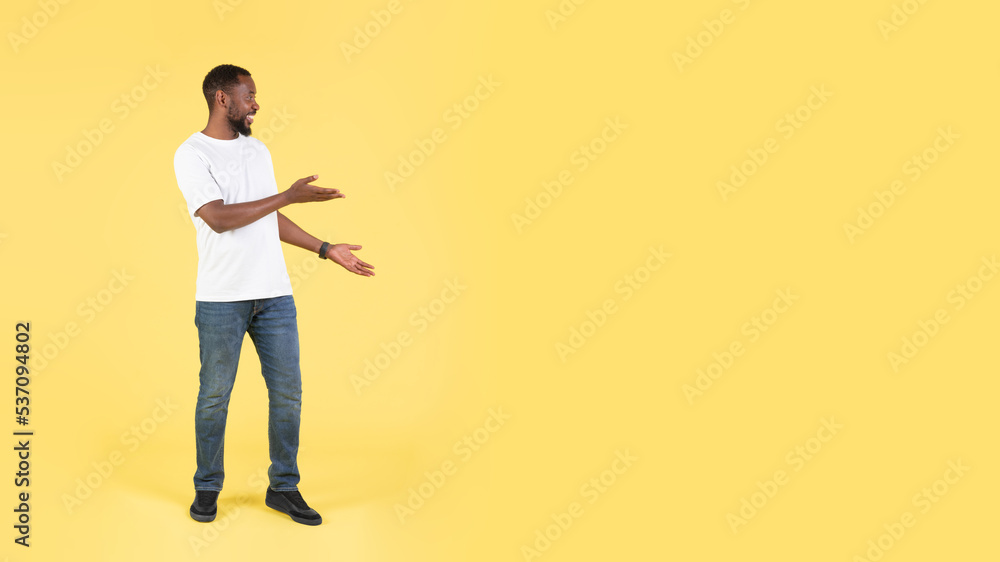 Happy Black Guy Pointing Aside With Both Hands, Yellow Background Happy Black Guy Pointing Aside With Both Hands, Yellow Background