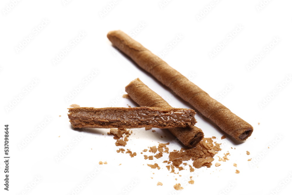 Waffle chocolate sticks broken and crumbs with of cream black chocolate and orange, isolated on white Waffle chocolate sticks broken and crumbs with of cream black chocolate and orange, isolated on white