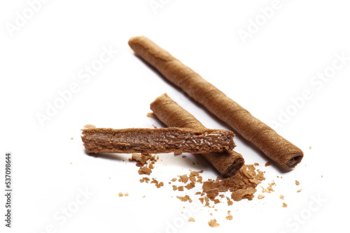 Waffle chocolate sticks broken and crumbs with of cream black chocolate and orange, isolated on white
