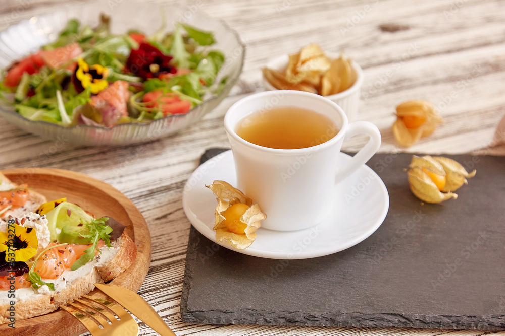 Healthy breakfast pescetarian salad and toasts with smoked salmon, vegetables, greens and edible flowers. Healthy breakfast pescetarian salad and toasts with smoked salmon, vegetables, greens and edible flowers.