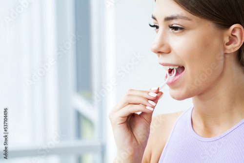 Smiling female cleaning teeth use dental floss