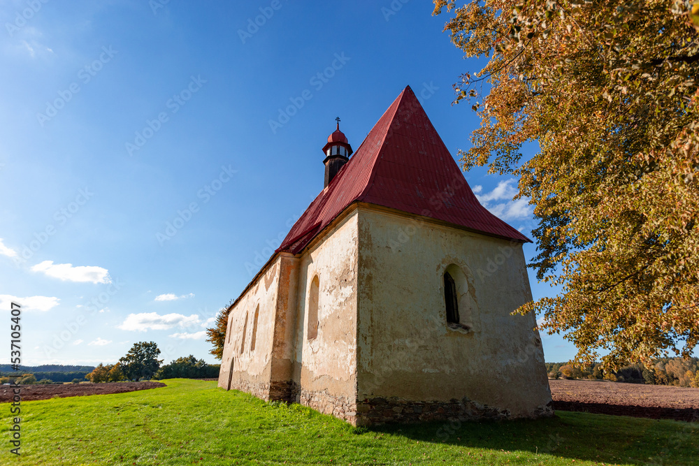 Old church in the autumn field. Dobronice u Bechyne, Czech republic.