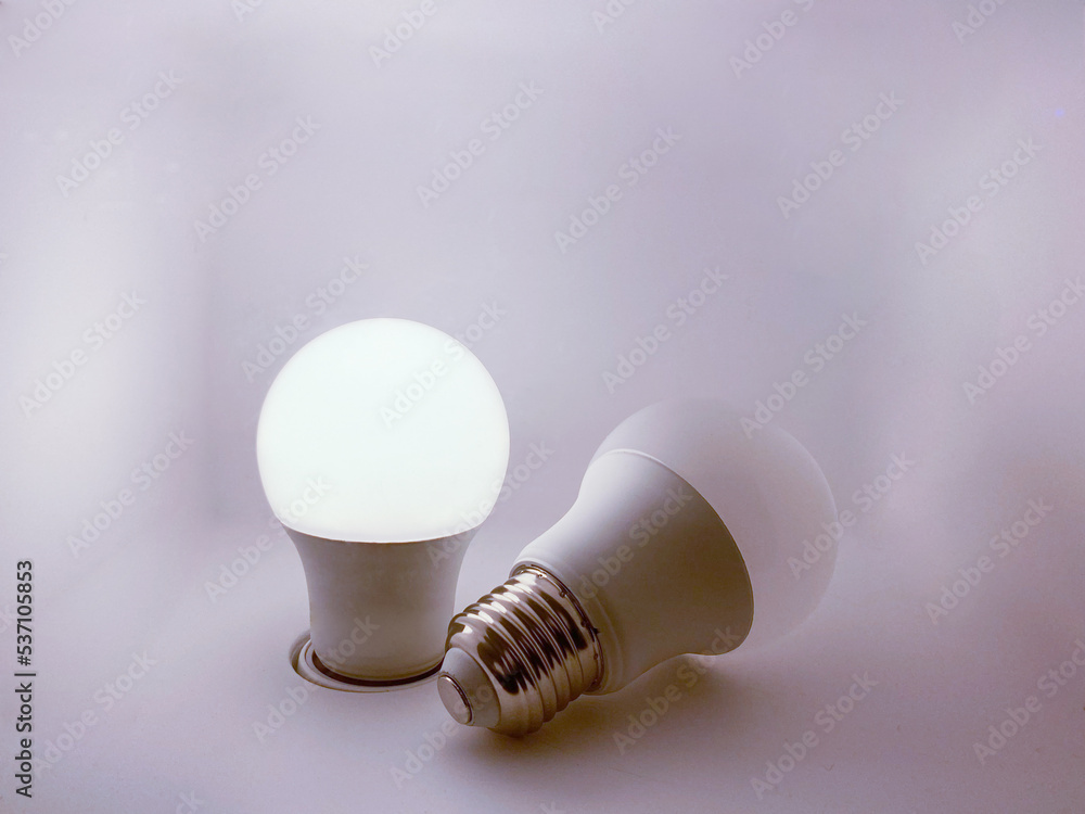 Two LED bulbs, one on and one off, in a bottomless box. Two LED bulbs, one on and one off, in a bottomless box.