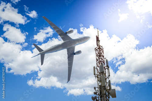 Mobile phone cell tower with 5G on the C Band frequencies with aircraft on the background photo