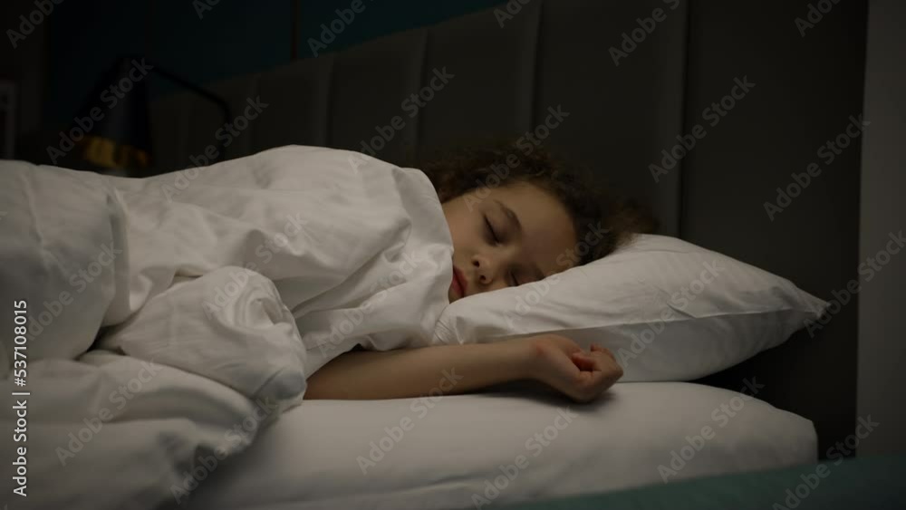 Sleeping baby in bed.Child little baby girl sleeps sweetly in his crib and smiles in his sleep.Tracking shot sleeping baby at midnight. Sleeping baby in bed.Child little baby girl sleeps sweetly in his crib and smiles in his sleep.Tracking shot sleeping baby at midnight.