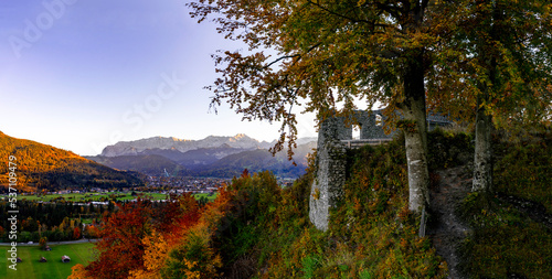 Panorama viewfrom ancient medieval castle ruin Burgruine Werdenfels on Loisach Valley, Garmisch-Partenkirchen and the mountains Alpspitze, Zugspitze and Wetterstein in autumn photo