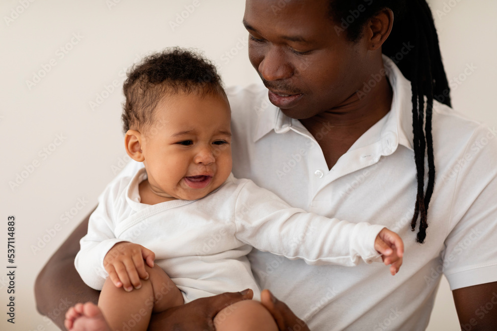 Portrait Of Little Black Baby Crying In Father's Arms Portrait Of Little Black Baby Crying In Father's Arms