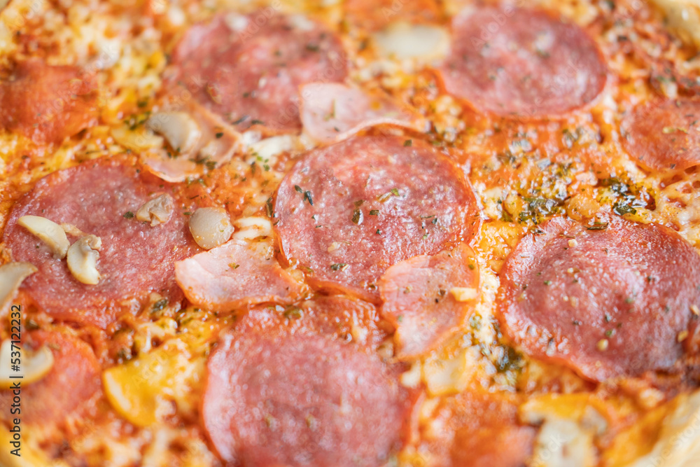 Hot meat pizza with salami, bacon and cheese. Selective focus. Hot meat pizza with salami, bacon and cheese. Selective focus.