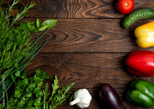 greens and vegetables on a wooden background
