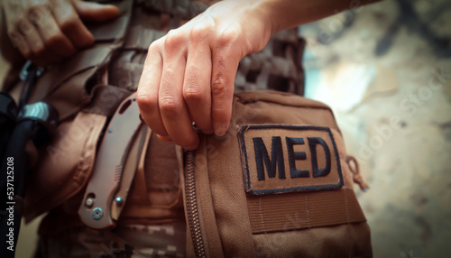 A soldier, a tactical medic opens a first aid kit, close-up view.