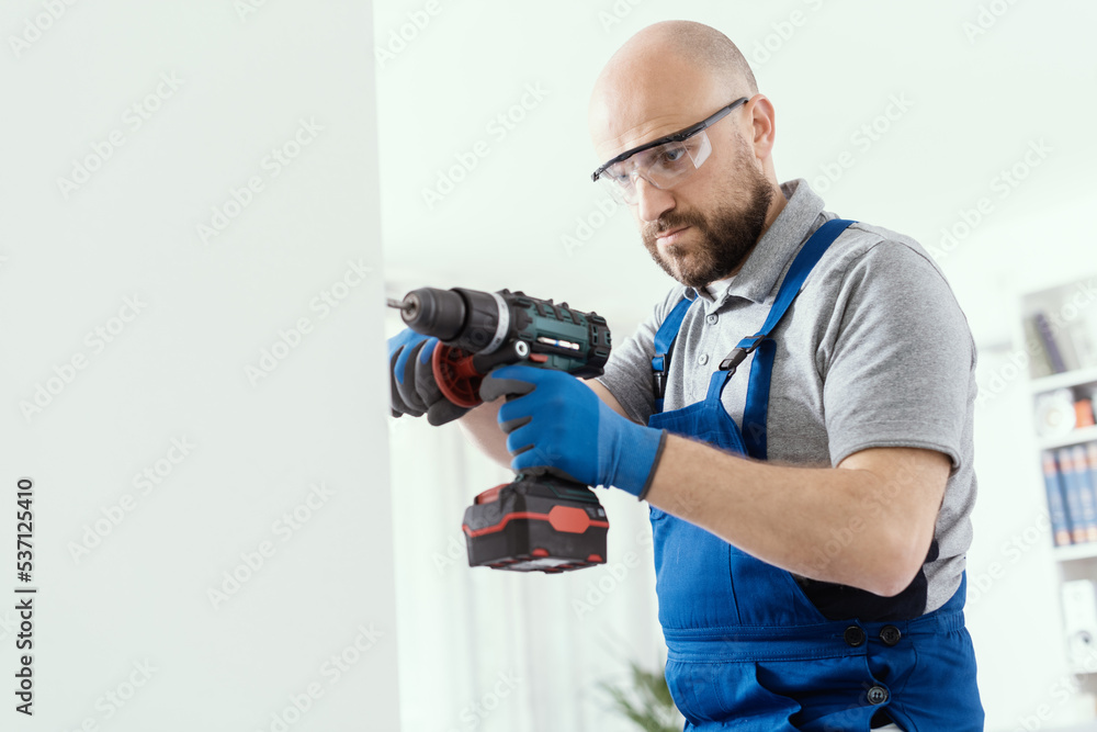 Professional handyman using a drill Professional handyman using a drill