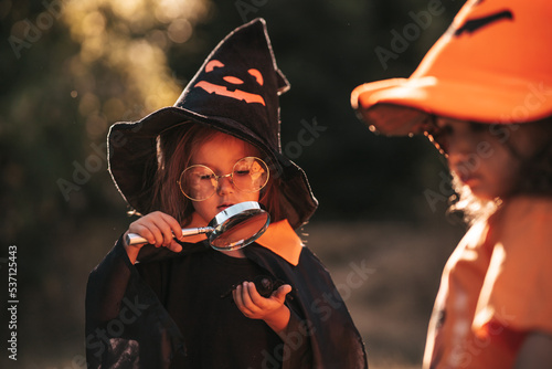 two little girls of three years old celebrate Halloween in nature photo