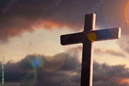 Wooden cross in the sky with light clouds.