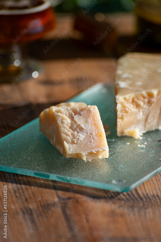 Cheese pairing with drinks,  parmigiano reggiano or parmesan cheese and French apple cider served outdoor