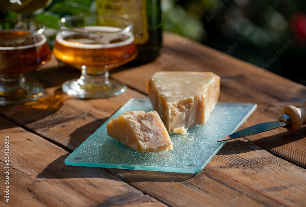 Cheese pairing with drinks, parmigiano reggiano or parmesan cheese and French apple cider served outdoor Cheese pairing with drinks, parmigiano reggiano or parmesan cheese and French apple cider served outdoor