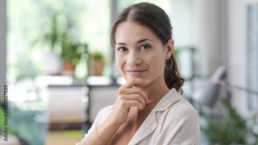 Confident woman thinking with hand on chin