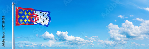 Pays de la Loire - France flag waving on a blue sky in beautiful clouds - Horizontal banner 