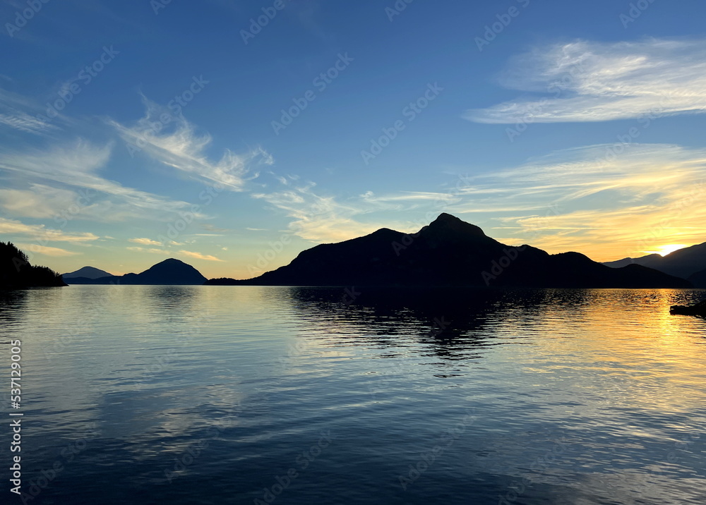 Background for travel travel agency Porteau Cove Provincial Park Sunset city immersed in water reflecting in the Pacific Ocean creating mirror image The camera moves slowly capturing beauty of nature 