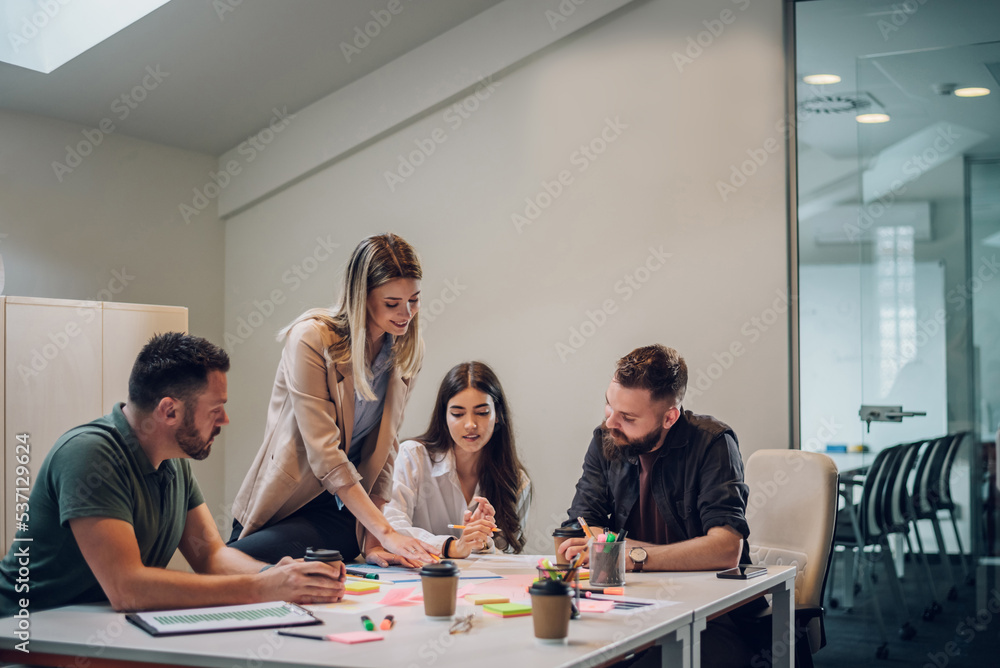 Group of colleagues talking about projects during a meeting in a boardroom Group of colleagues talking about projects during a meeting in a boardroom