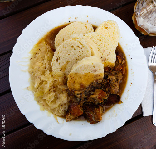 Traditional czech cuisine, moravsky vrabec with sauerkraut and potato-dough dumplings photo