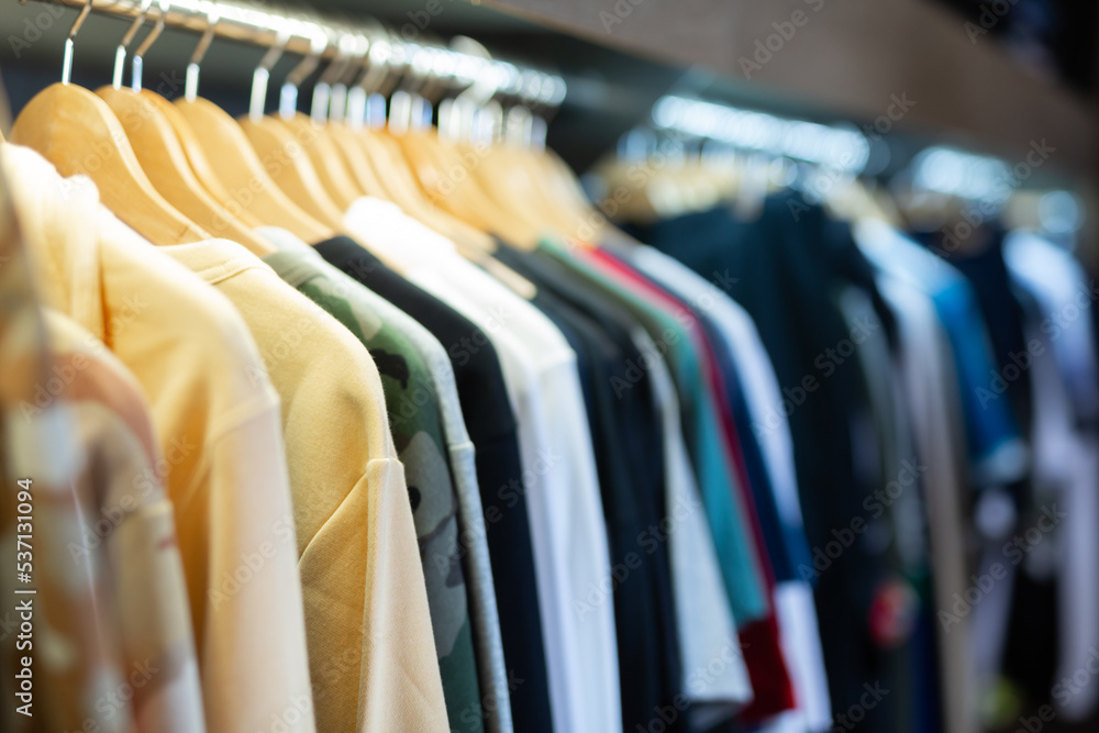 Obraz premium Male clothes on hangers in apparel boutique