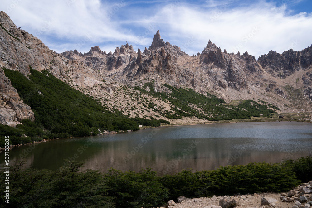 Alpine landscape. View of Toncek lake at the top of Catedral hill in Bariloche. The rocky mountains in the background. Alpine landscape. View of Toncek lake at the top of Catedral hill in Bariloche. The rocky mountains in the background.