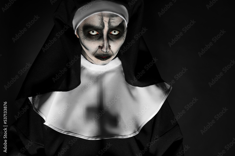 Portrait of scary devilish nun on black background, space for text. Halloween party look Portrait of scary devilish nun on black background, space for text. Halloween party look