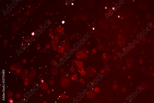 Red glitter vintage lights background.  red bokeh shiny on dark background.