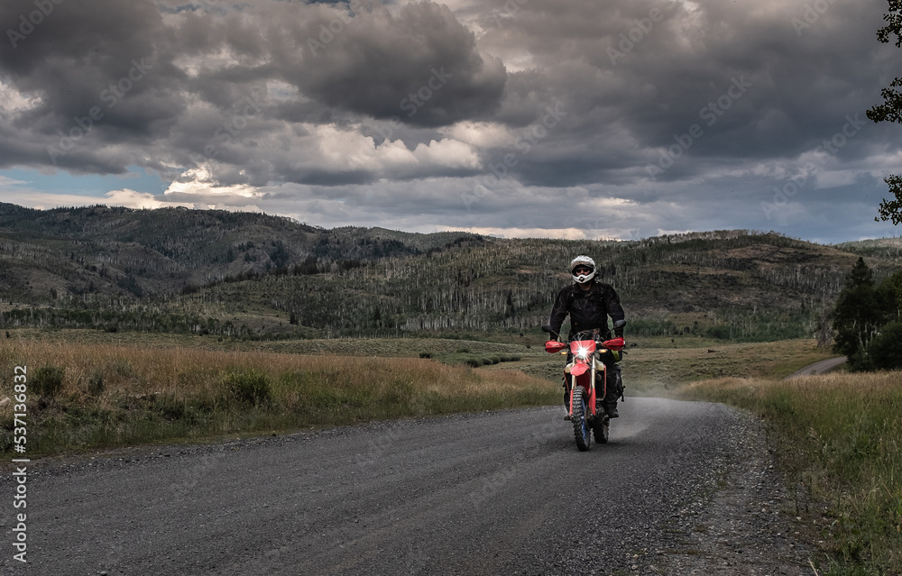Off road motorcyclist riding on the continental Divide Ride in Colorado at dusk. Off road motorcyclist riding on the continental Divide Ride in Colorado at dusk.