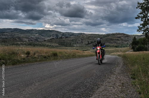 Off road motorcyclist riding on the continental Divide Ride in Colorado at dusk.   © Chris