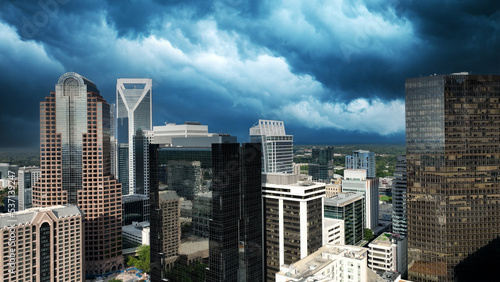 Dramatic storm clouds over downtown Charlotte North Carolina.  Deep blue clouds mixed with sweeping white storm clouds over city builds