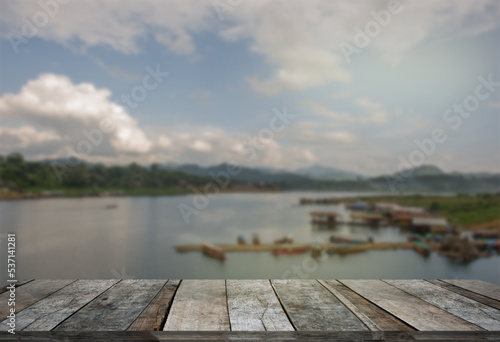 Fototapeta Naklejka Na Ścianę i Meble -  beautiful view  of river with empty wooden table, summer holiday background. free space for text or product placement.