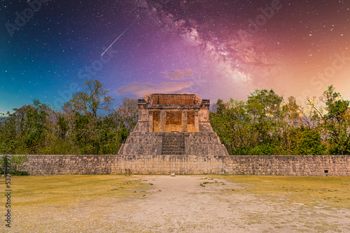 Temple of the Bearded Man at the end of Great Ball Court for playing pok-ta-pok near Chichen Itza pyramid, Yucatan, Mexico. Mayan civilization temple ruins with Milky Way Galaxy stars night sky