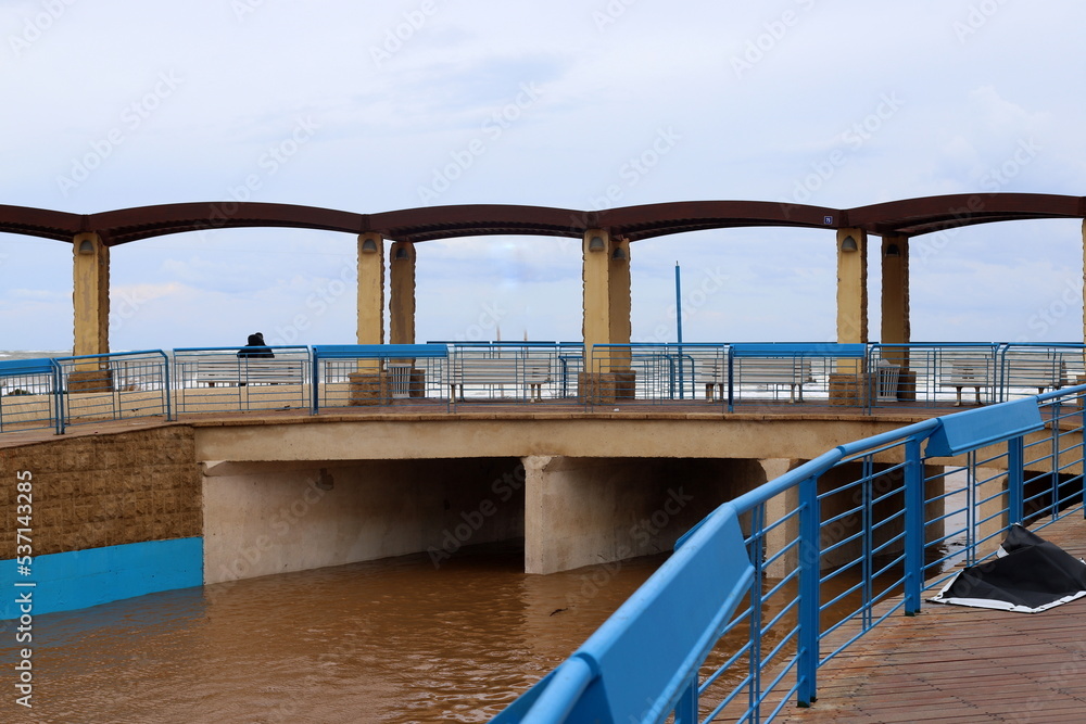 High concrete banks of a stormy river. High concrete banks of a stormy river.