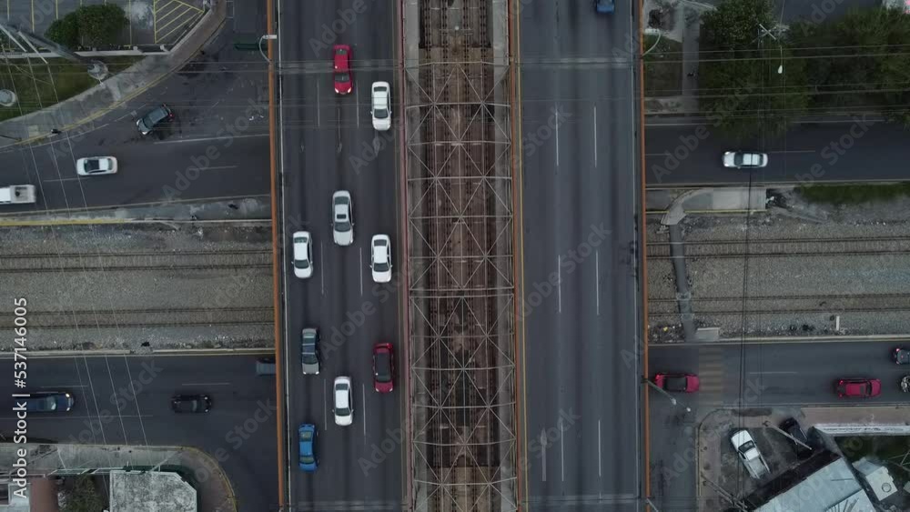 aerial train going around and below cars and train rails aerial train going around and below cars and train rails