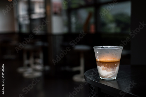 Dirty Coffee - A glass of espresso shot mixed with cold fresh milk in coffee shop cafe and restaurant